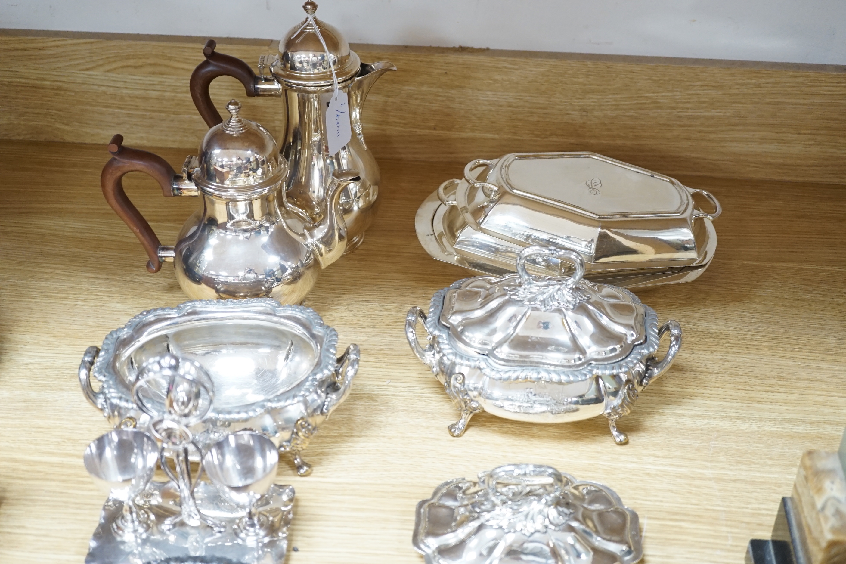 Silver plated items including two wine coasters, tureens and egg cup stand, largest 24cm high